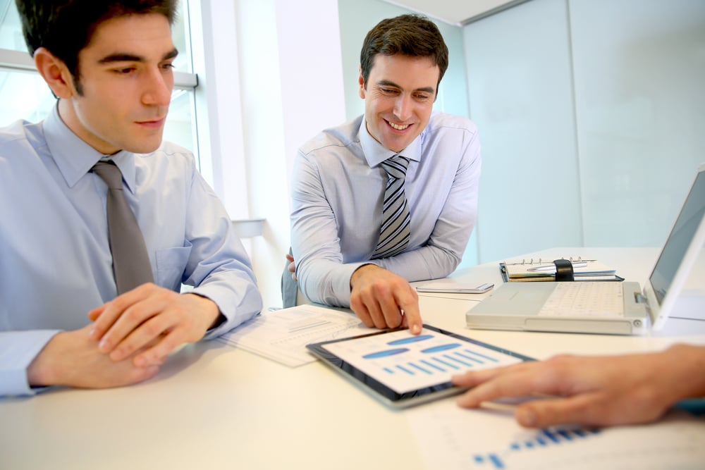 Sales people working around table