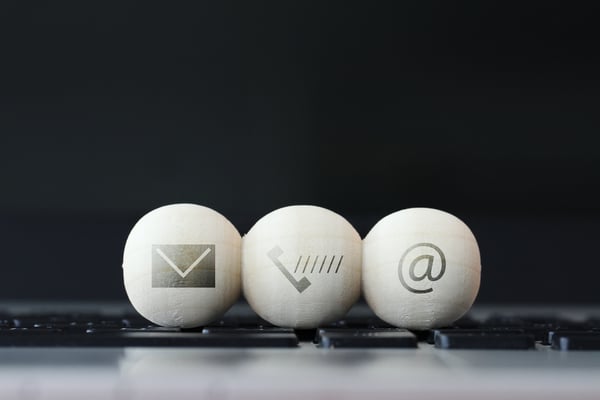 icon on wooden ball of website and internet contact us page concept on computer laptop keyboard