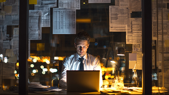 Hotel_executive_late_at_night_surrounded_by_p_d545fc78-d750-4e2e-a951-9806b36c60a7